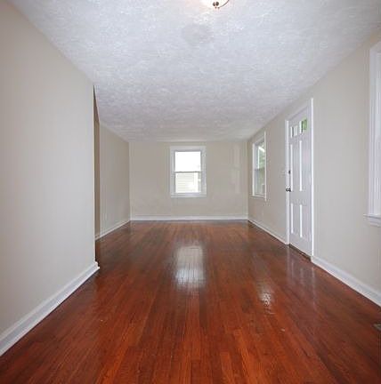 Check out this huge living room with refinished original hardwoods.