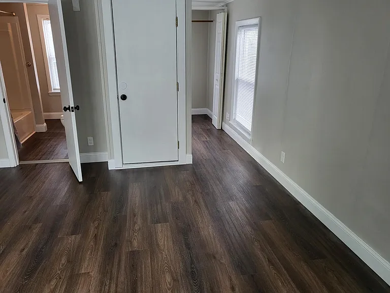 View into storage closet and bathroom