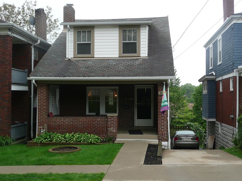 Nice front porch. Driveway will accommodate two cars.