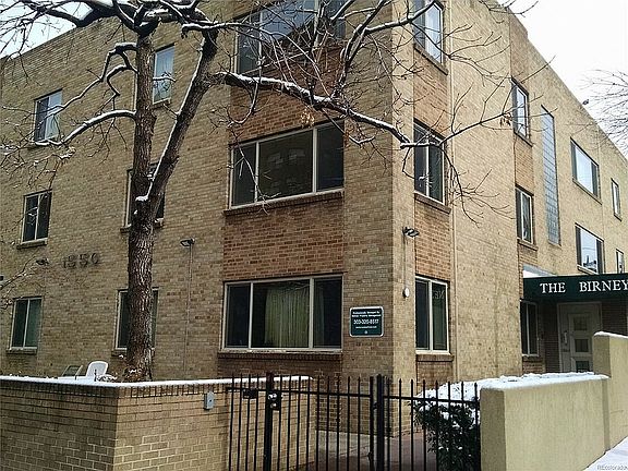 Explore this charming urban residence, perfectly nestled against a picturesque winter backdrop.