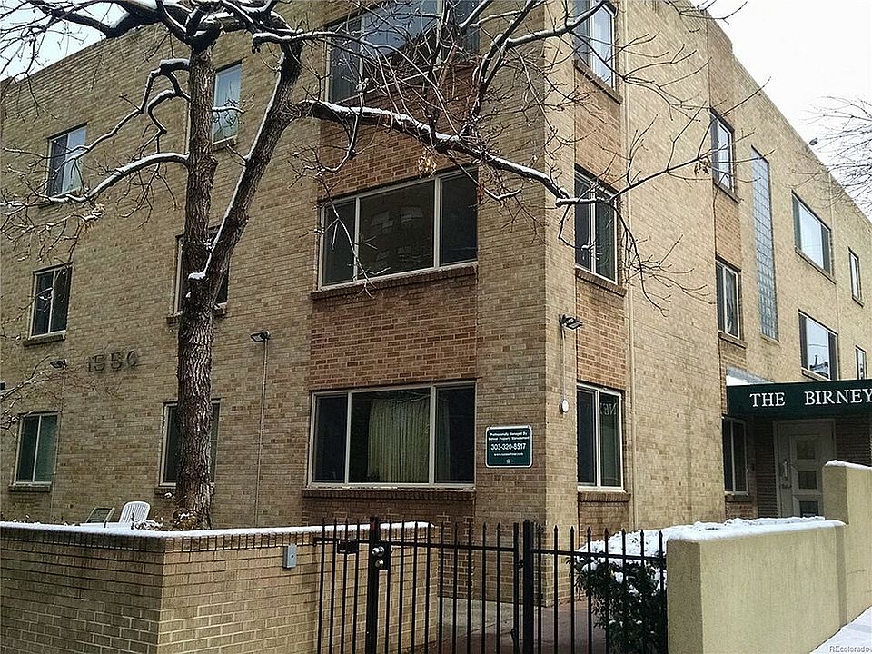 Explore this charming urban residence, perfectly nestled against a picturesque winter backdrop.