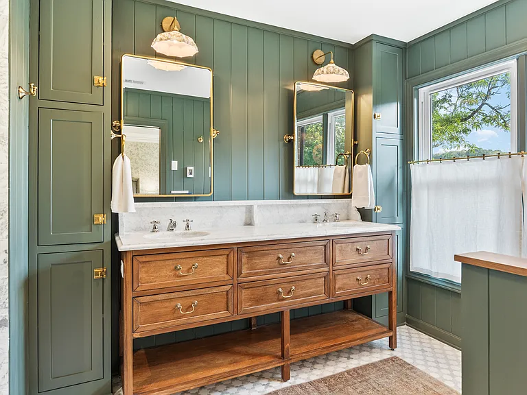 Beautiful primary bathroom attached to bedroom #1. Enjoy a spacious double vanity, huge standing shower, and lots of natural light.