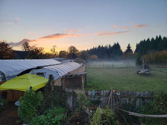 Greenhouses at sunset behind 2 bed 2 bath home