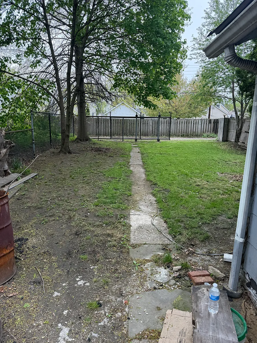 No section 8 Updated single family ranch located between a neighborhood garden and vacant lot It's a fenced in lot with a sliding entry gate to park inside property House has alley in rear of property where u enter gate Concrete counters — photo 4