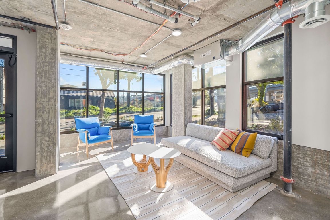 Experience the comfort and elegance of our spacious living room, featuring a cozy couch, stylish tables, and ample natural light.