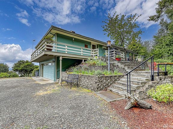 The home has a 2-car garage with add'l work space.  The stairway leads to the front entrance of the home. 
