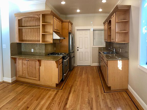 Kitchen with gas stove, dishwasher, disposal. Back door leads to garbage area and garage.
