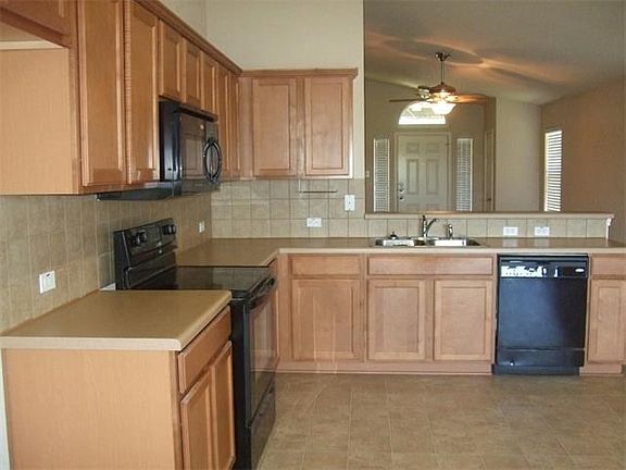 Kitchen/breakfast combo is open to living area.