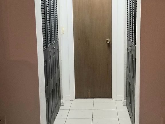 Closets in downstairs master and door leading to connected bathroom