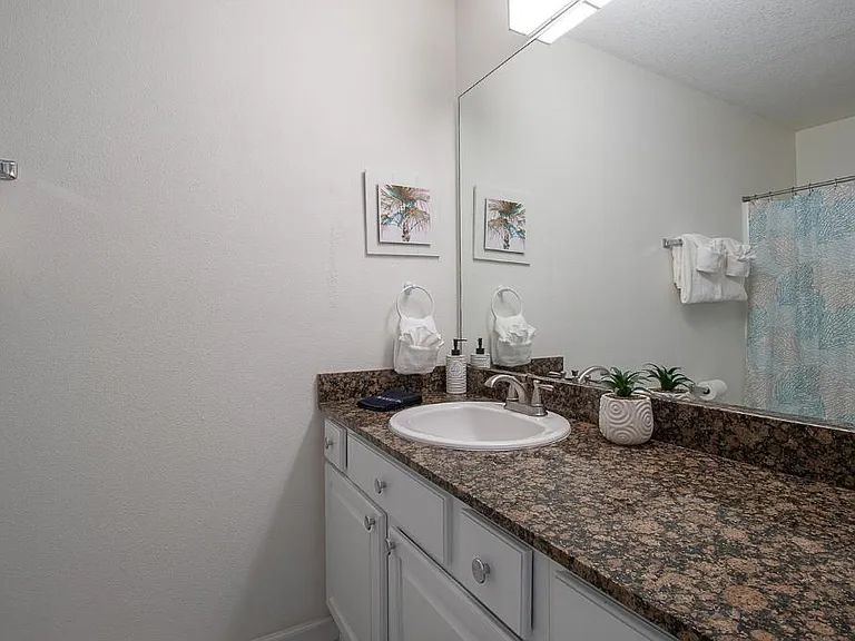Private bathroom with rain shower across from private bedroom. Indulge in a luxurious and tranquil bathing experience.