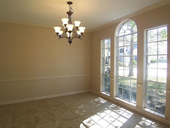 Entertaining size formal dining room enjoys crown molding, chair railing, upgraded chandalier and a 