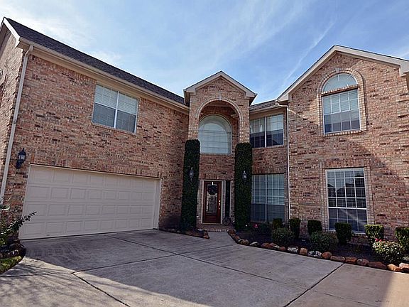 Gorgeous home with great curb appeal. Vine lined columns at the front door. What an entrance to this beauty!