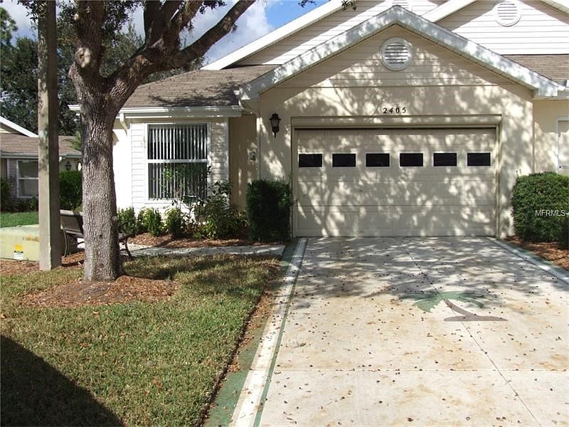 FRONT OF HOME (COLOR COAT ON DRIVEWAY AND WALKWAY TO ENTRY AND ROLL DOWN SCREEN ON GARAGE DOOR.