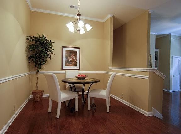 Dining area with hardwoods and chair rail. Great flow in this unit