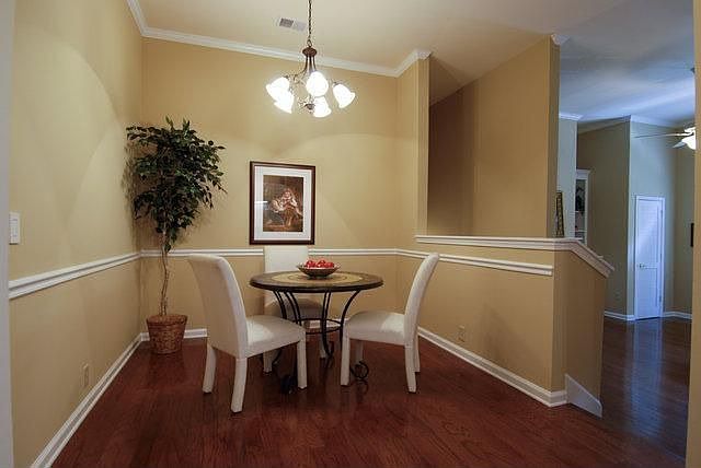 Dining area with hardwoods and chair rail. Great flow in this unit
