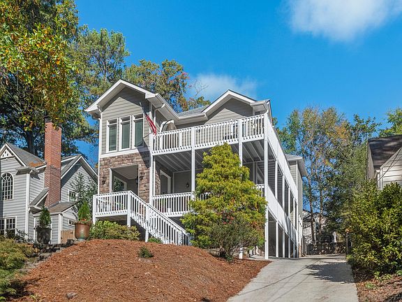 Wrap around porch on main and upper levels, offering beautiful treetop views of the neighborhood.