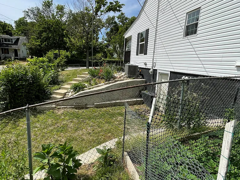 A gated driveway and second entrance to the basement/cellar storage area on Robins Court side of the house. A cultivated garden spot has good soil for your vegetable.