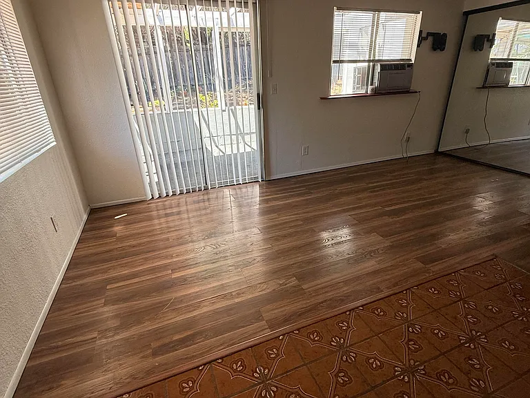 Living area looking out to covered patio and backyard space.