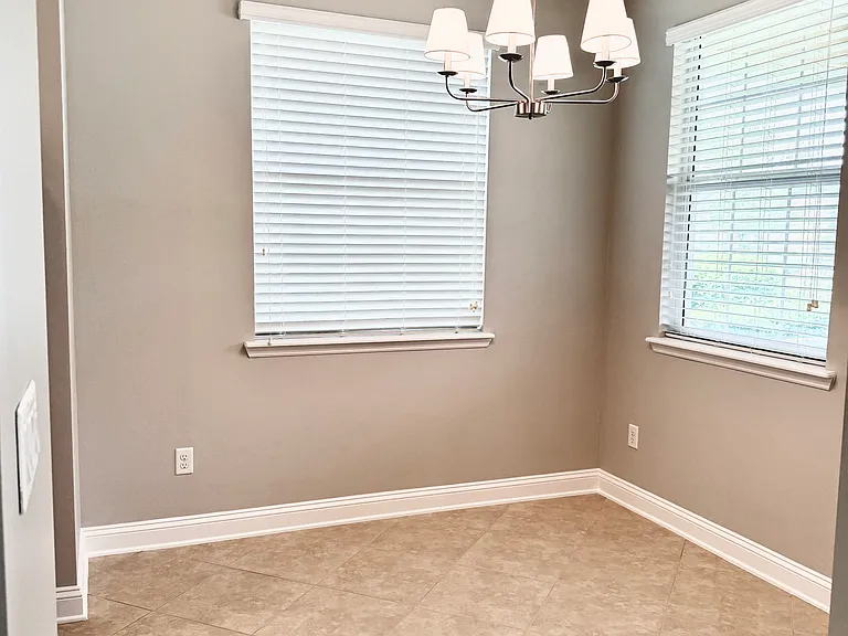 Breakfast nook. 3 windows. View from foyer. Entry also on left directly to kitchen