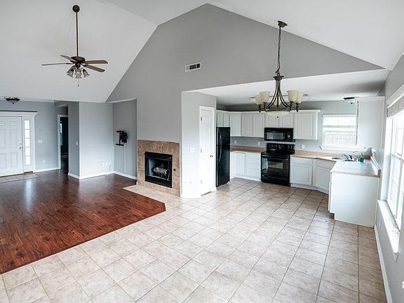 Open living area, dining area, & kitchen. Lots of natural Light. Light fixtures have been updated since photographed.