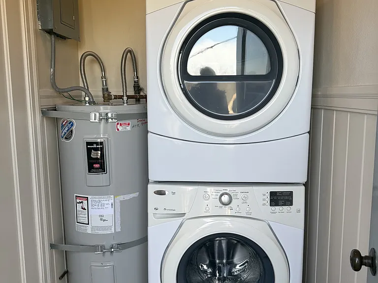 Dedicated washer/dryer and water heater in separate room inside the back entrance.