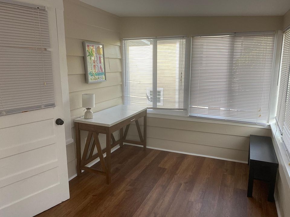 Sunroom is filled with light, surrounded by all windows for a great sun drenched work space, new split a/c unit with remote