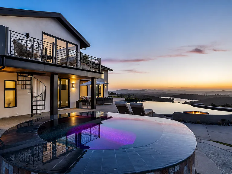 When sitting in the outdoor spa, there is direct line of site over the vanishing edge pool to Lake Jennings making you feel like Lake Jennings is part of your backyard. This was not by accident! You can also see the spiral staircase access.