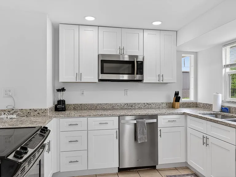 Ample white shaker cabinets, enough for each Member to have their own space.