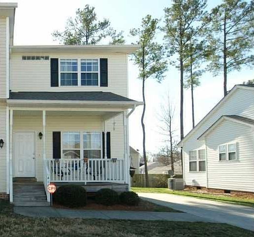 This well-maintained, 2 story townhome has a rocking chair front porch.