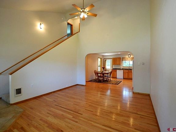 Hardwood floors, pellet stove, open kitchen/dining, back yard access, attached laundry room.