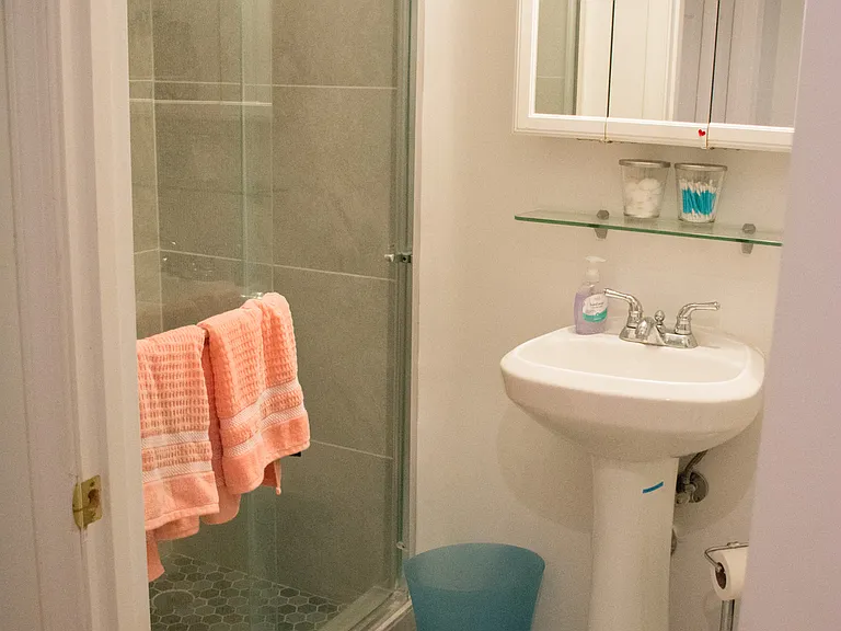 Basement Bathroom, tile floor & walls.
Sliding glass doors.
