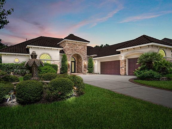 Stunning 1.5 story Mediterranean lakefront property in gated Manor Lake, with 3-car oversized garage.