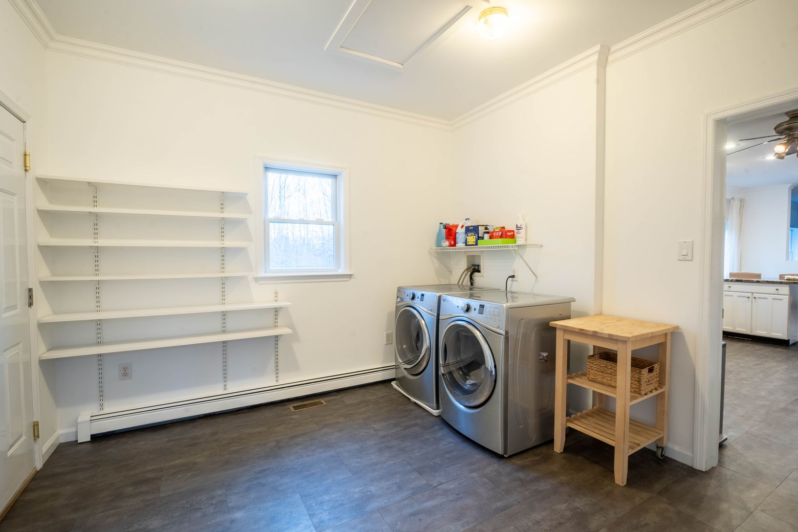  laundry room with washer, dryer, and plenty of shelving for shoes