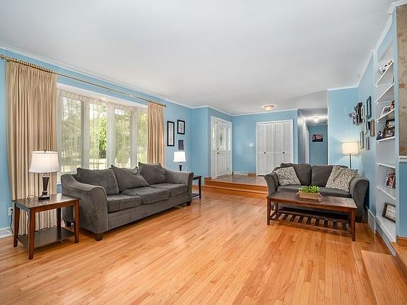 Sunken living room with Large bay window and hardwood floors.