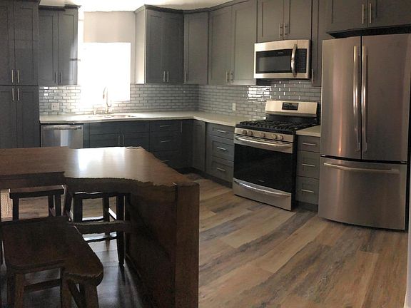 Fully renovated kitchen with new stainless steel appliances.