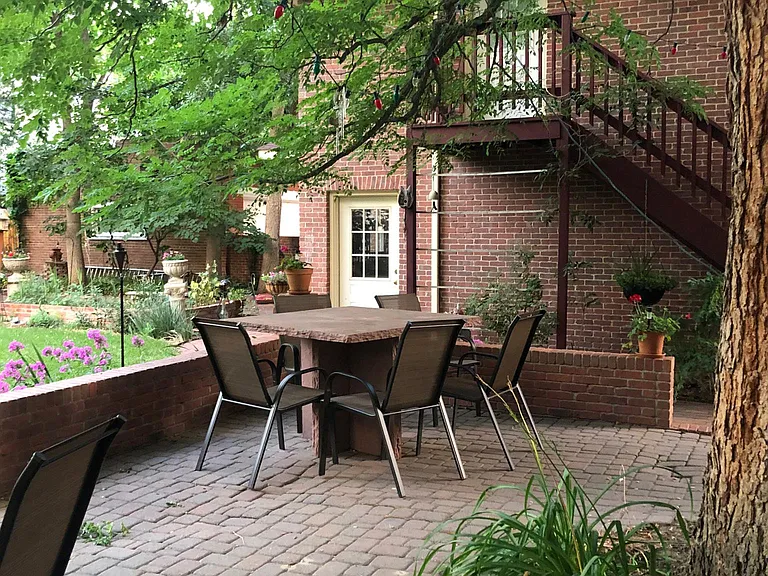 Patio and entrance door to the studio. The entrance door is above the exterior wood staircase.