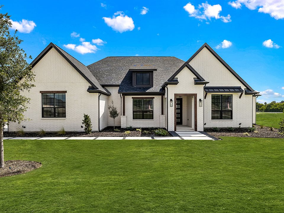 Stunning exterior of the Bradley with white brick and beautiful landscaping.