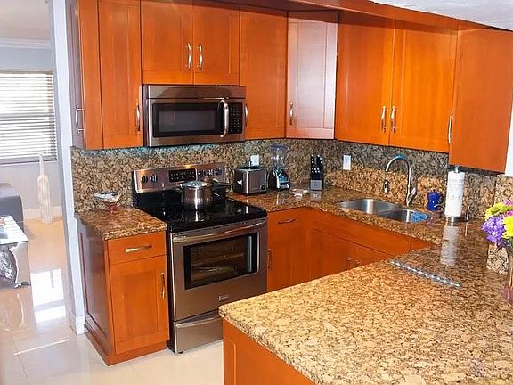 Updated kitchen with marble countertops, stainless steel appliances, and plenty of storage. Dishwasher less than one year old.