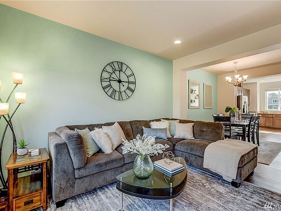 Spacious living room flows seamlessly with the dining area and kitchen - perfect for entertaining!