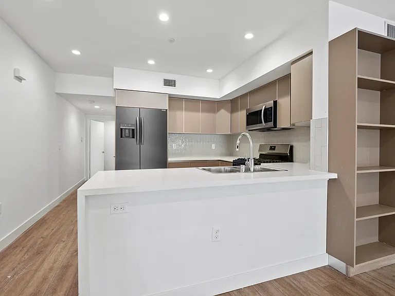 Open-Concept Kitchen with Countertop Bar and Dining Area with Built-In Shelving
