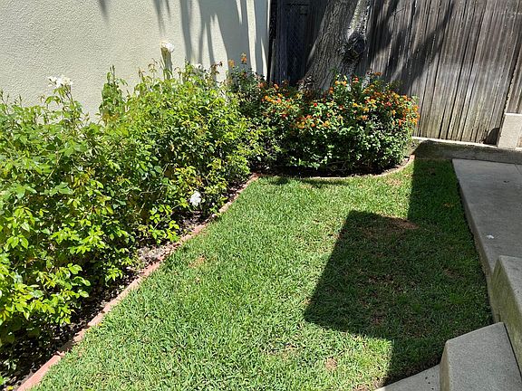 Back yard with automatic sprinklers. Gardner provided by landlord