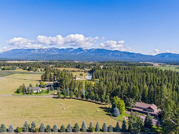 Aerial view looking towards Whitefish Mountain Resort. The house is in the lower right corner and the field in front of the house is part of this property. You can also see the driveway approach to the house. It is a nice, long, private drive.