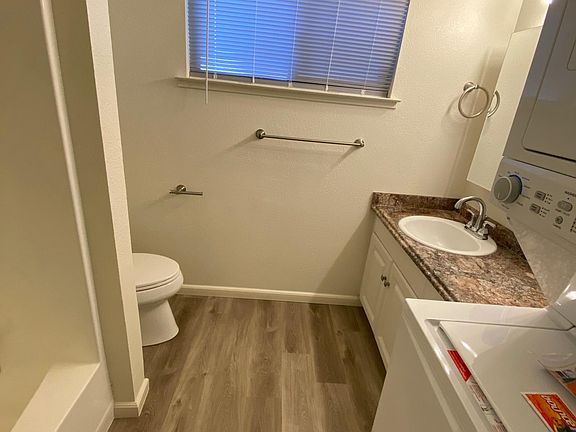 Bathroom with new washer-dryer unit on right side.