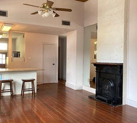 Large, spacious living/dining room with small bar between kitchen area