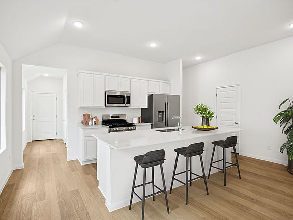 Kitchen in the Spruce home plan by Trophy Signature Homes - REPRESENTATIVE PHOTO