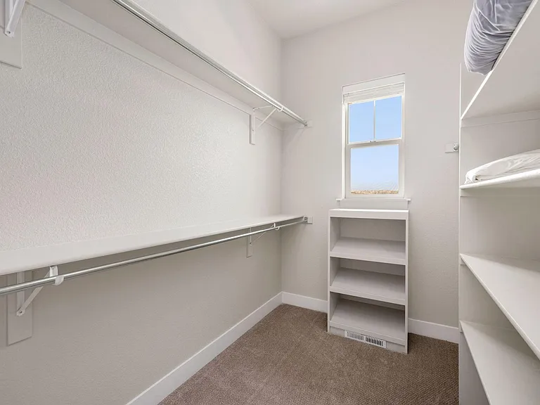 Large walk-in Master bedroom closet with shoe rack and plenty of space for clothes!