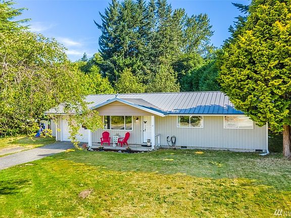 This rambler home has vinyl windows, cedar siding and metal roof for low maintenance.