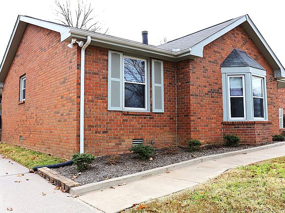 Front of house entryway with off street parking.