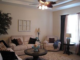 Living room has coffered ceiling and lake view!