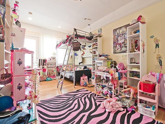 Top Unit - Bedroom with walk-in closet. Glass door leading to deck overlooking backyard.